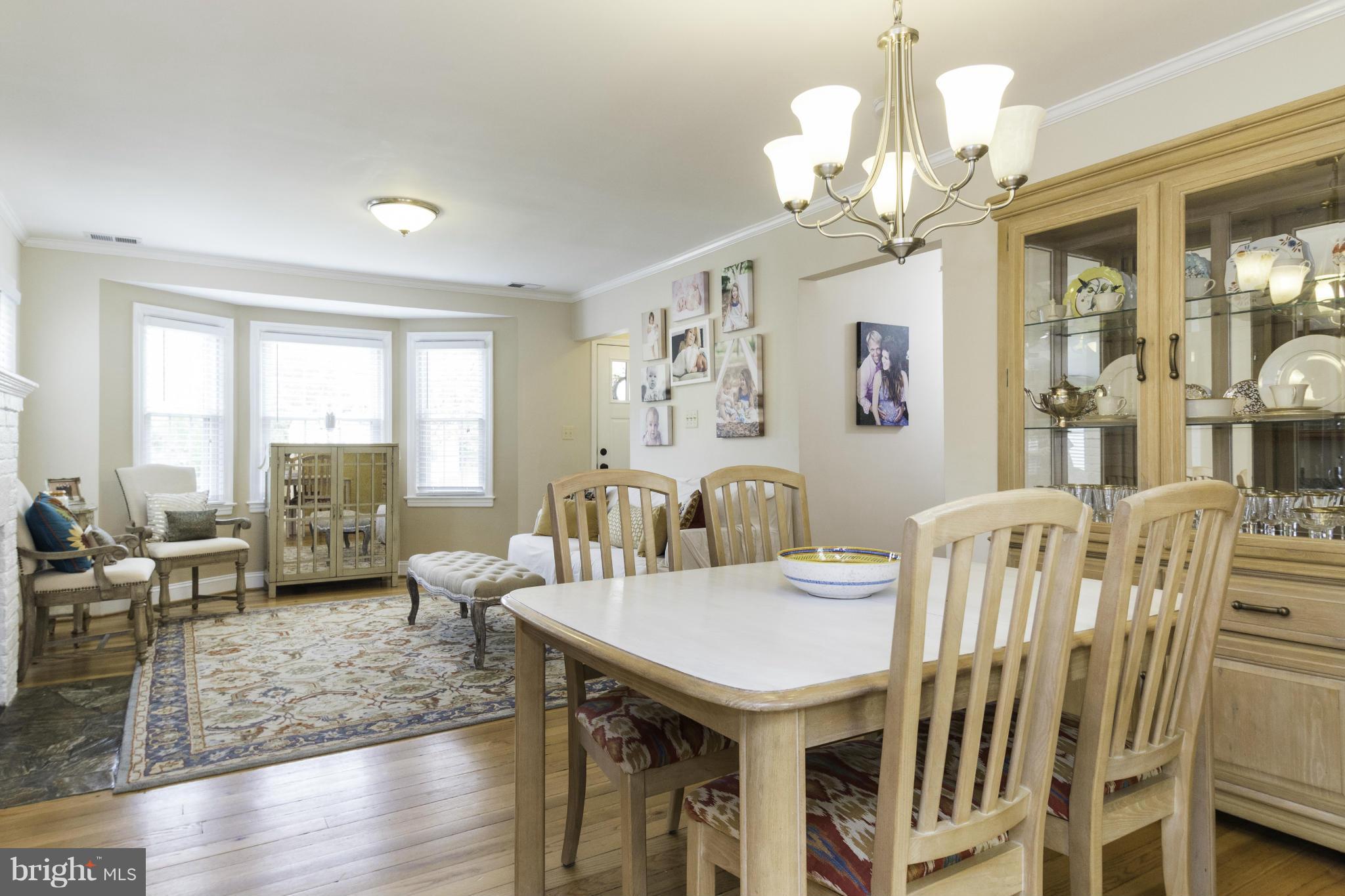 6600 Pine Road Alexandria, VA 22312 - Photo 6 of 28 a view of a dining room with furniture a chandelier and wooden floor