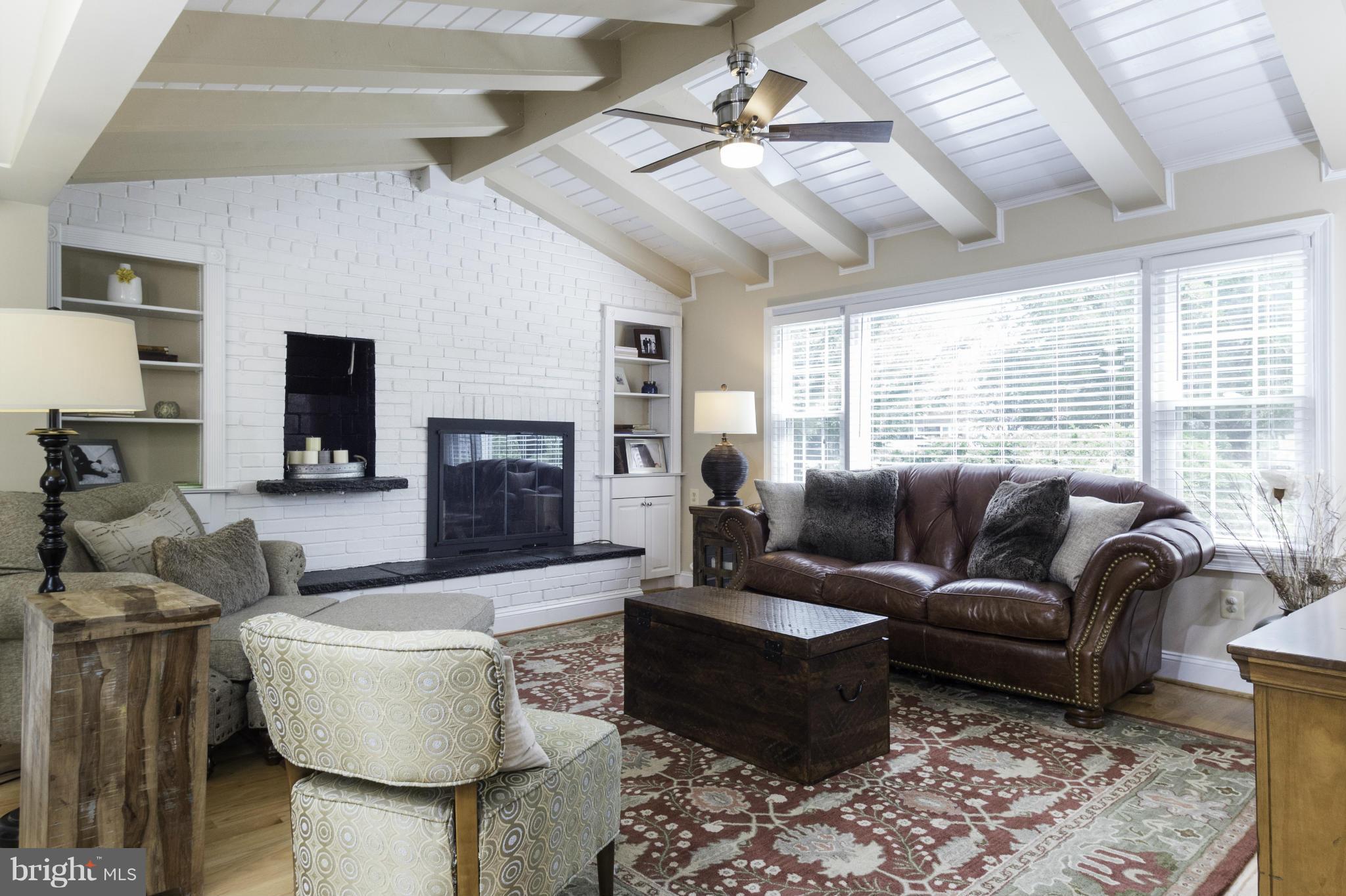 6600 Pine Road Alexandria, VA 22312 - Photo 7 of 28 a living room with furniture a fireplace and a large window