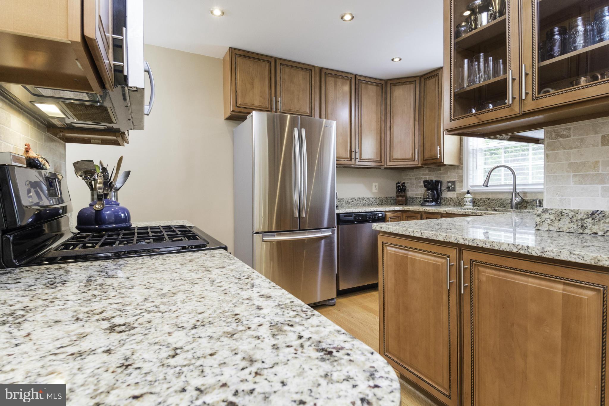 6600 Pine Road Alexandria, VA 22312 - Photo 9 of 28 a kitchen with granite countertop a refrigerator and a sink