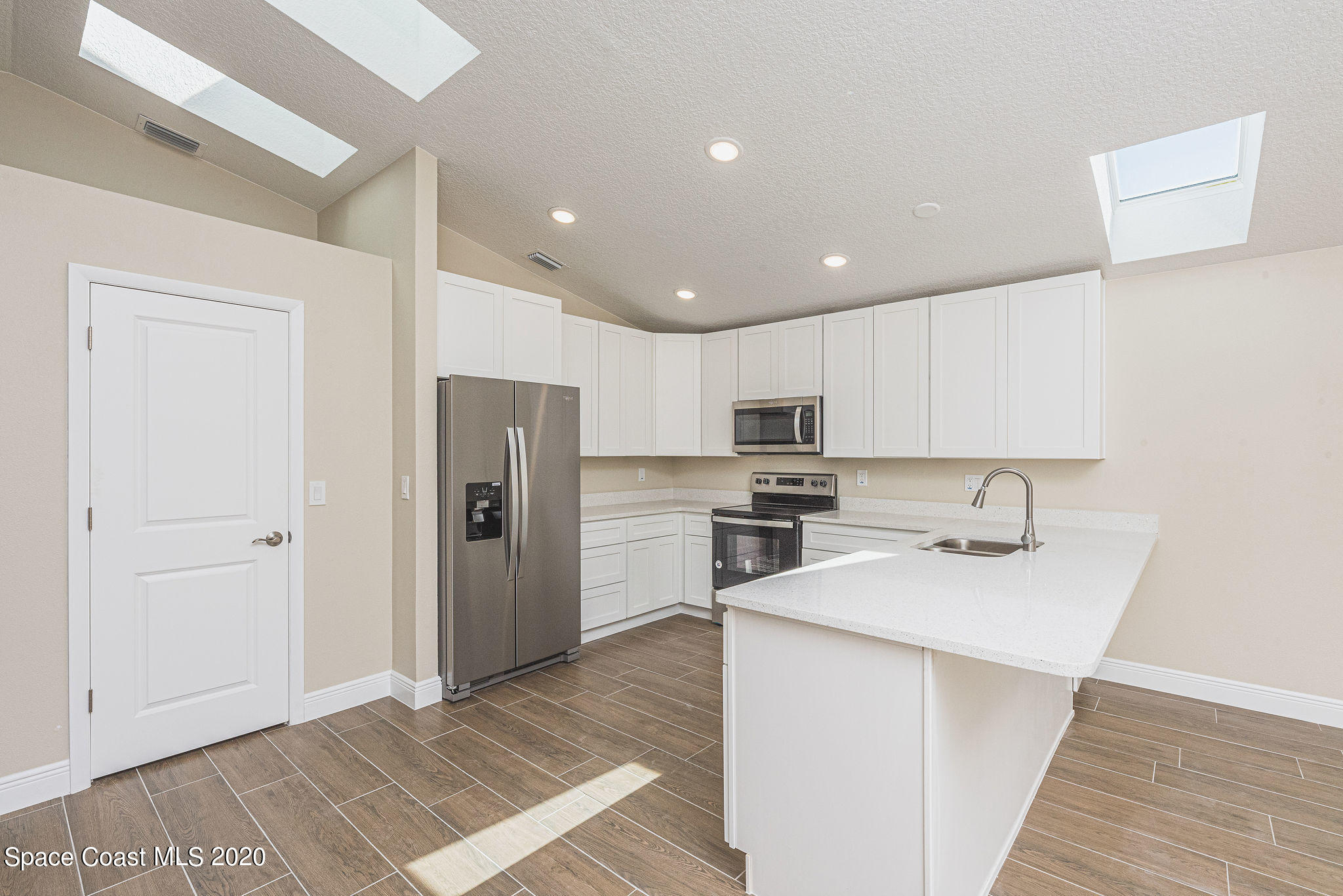 336 Myrtlewood Road Melbourne, FL 32940 - Photo 16 of 72 a kitchen with stainless steel appliances granite countertop a refrigerator sink and stove