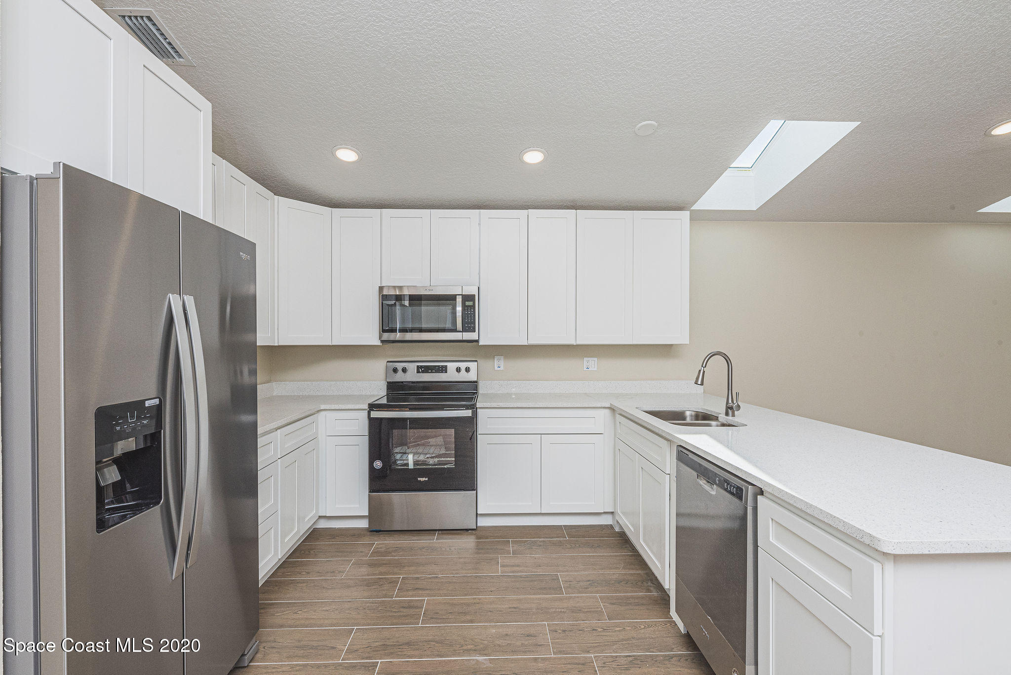 336 Myrtlewood Road Melbourne, FL 32940 - Photo 17 of 72 a kitchen with stainless steel appliances granite countertop a refrigerator sink and stove