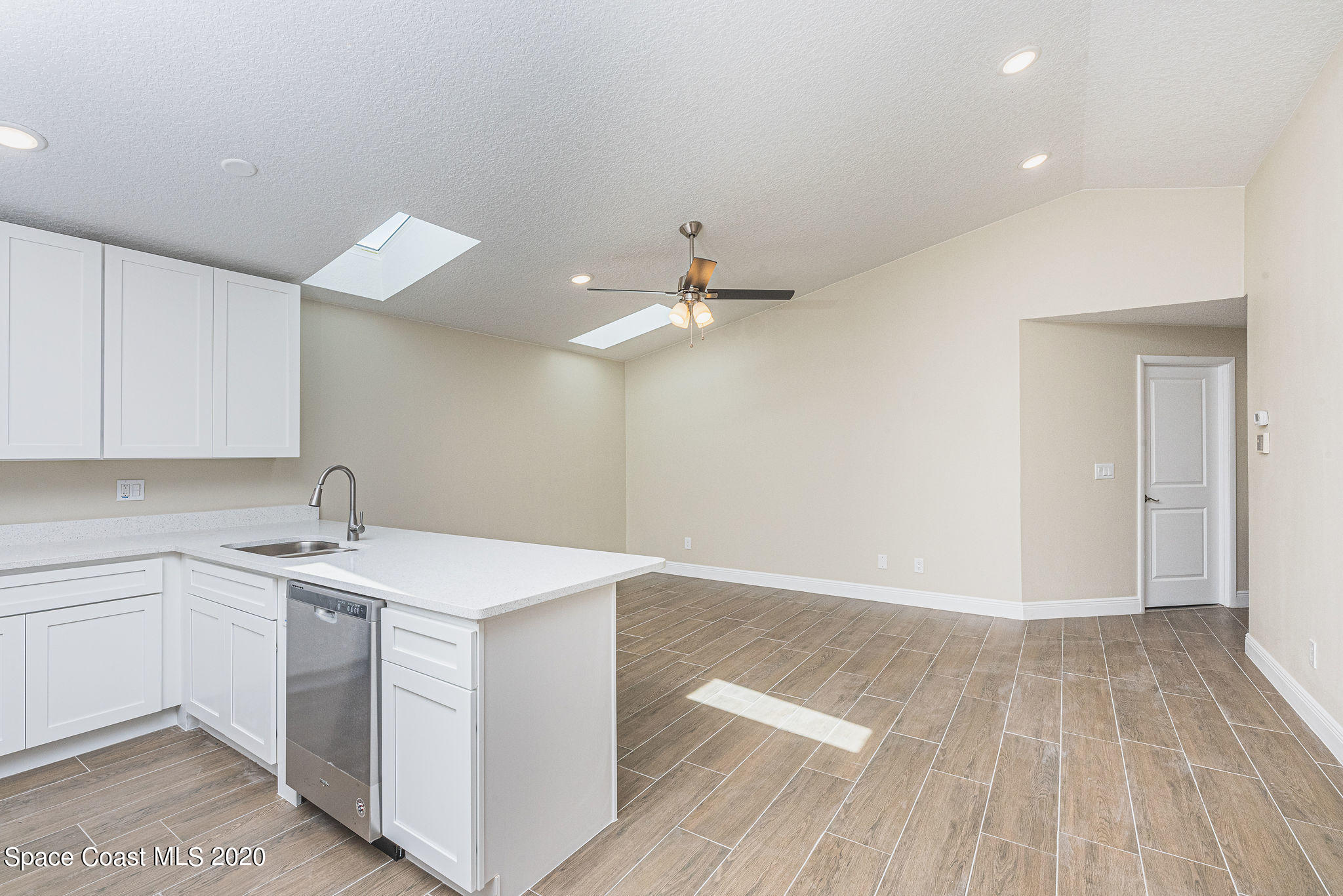336 Myrtlewood Road Melbourne, FL 32940 - Photo 18 of 72 a view of a kitchen with a sink cabinets and wooden floor
