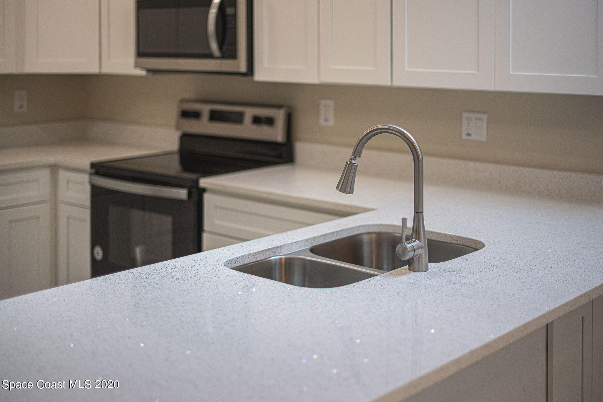 336 Myrtlewood Road Melbourne, FL 32940 - Photo 23 of 72 a kitchen with a sink and cabinets
