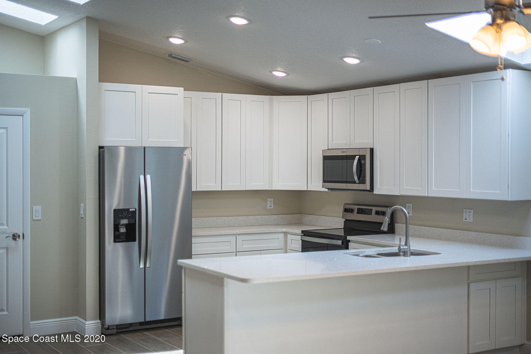 336 Myrtlewood Road Melbourne, FL 32940 - Photo 24 of 72 a kitchen with stainless steel appliances granite countertop a refrigerator a stove and a sink