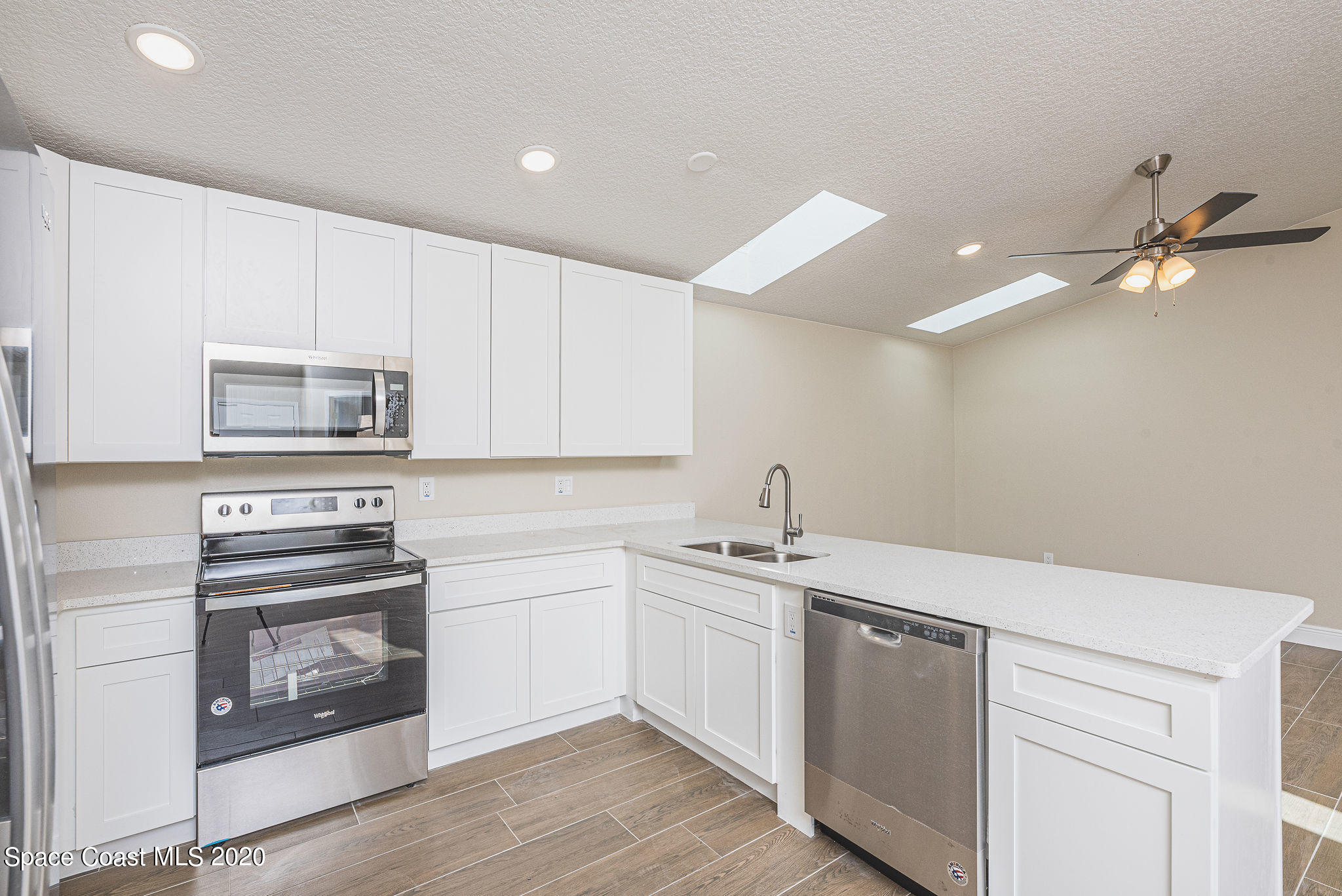 336 Myrtlewood Road Melbourne, FL 32940 - Photo 25 of 72 a kitchen with appliances cabinets and a sink