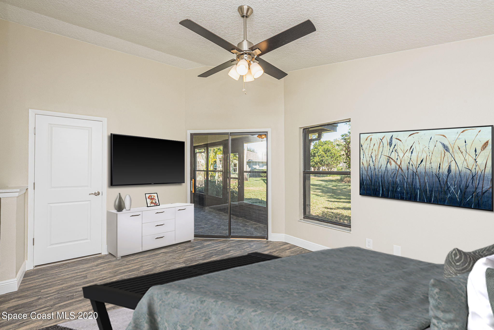 336 Myrtlewood Road Melbourne, FL 32940 - Photo 34 of 72 a bedroom with a bed and a flat screen tv