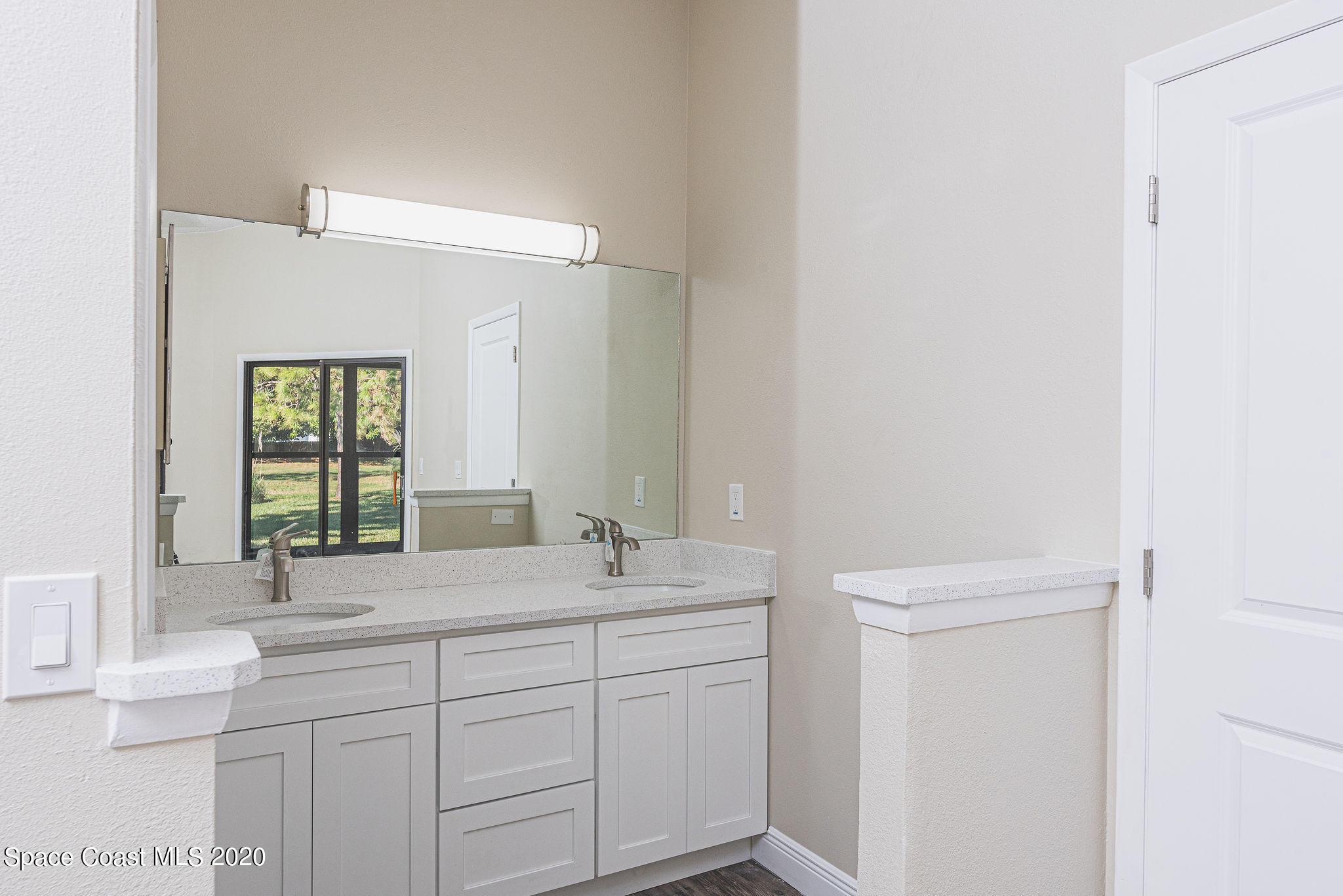 336 Myrtlewood Road Melbourne, FL 32940 - Photo 37 of 72 a bathroom with a sink and a mirror