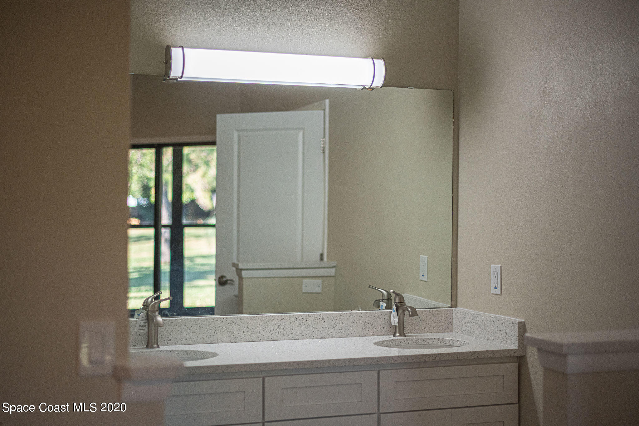 336 Myrtlewood Road Melbourne, FL 32940 - Photo 41 of 72 a bathroom with a sink and a mirror