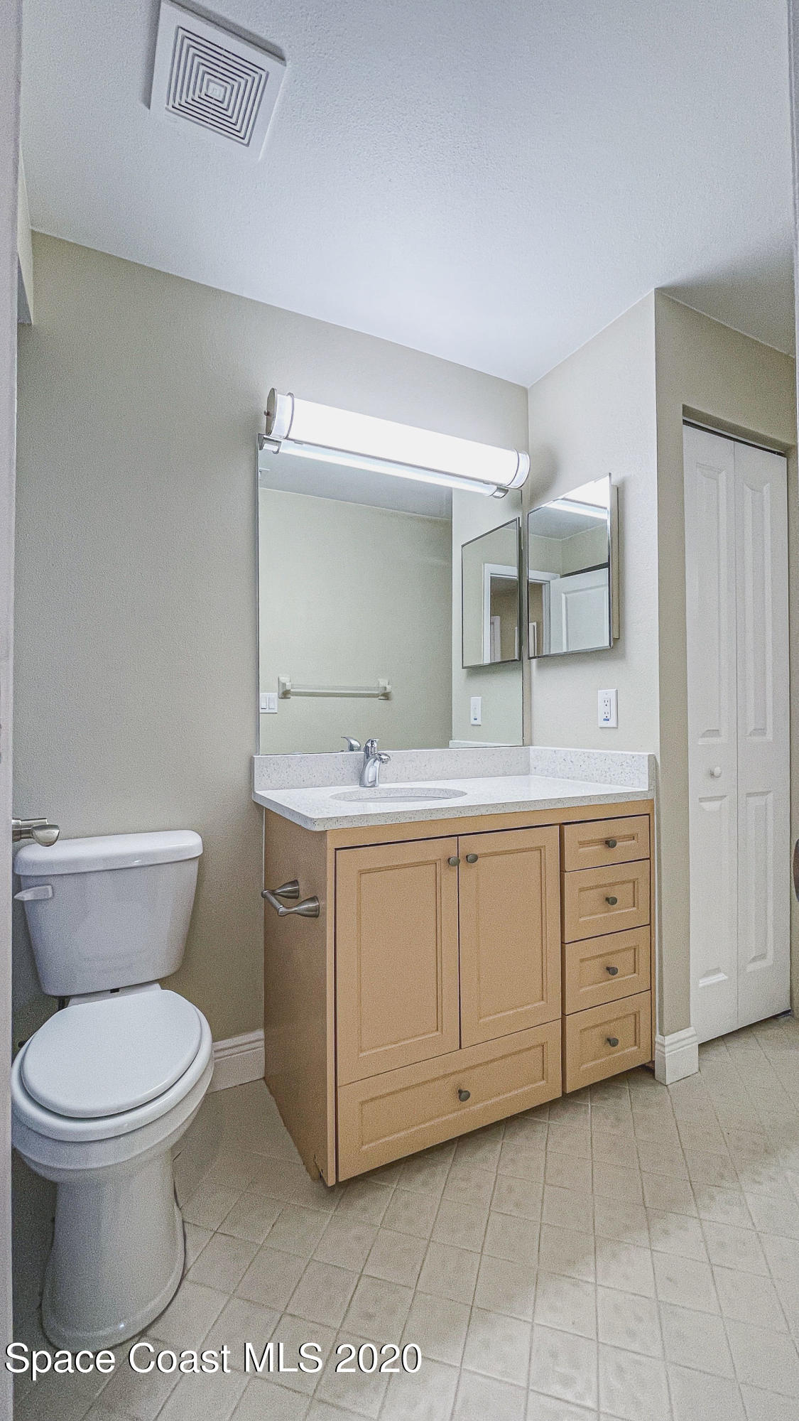 336 Myrtlewood Road Melbourne, FL 32940 - Photo 46 of 72 a spacious bathroom with a toilet sink and mirror