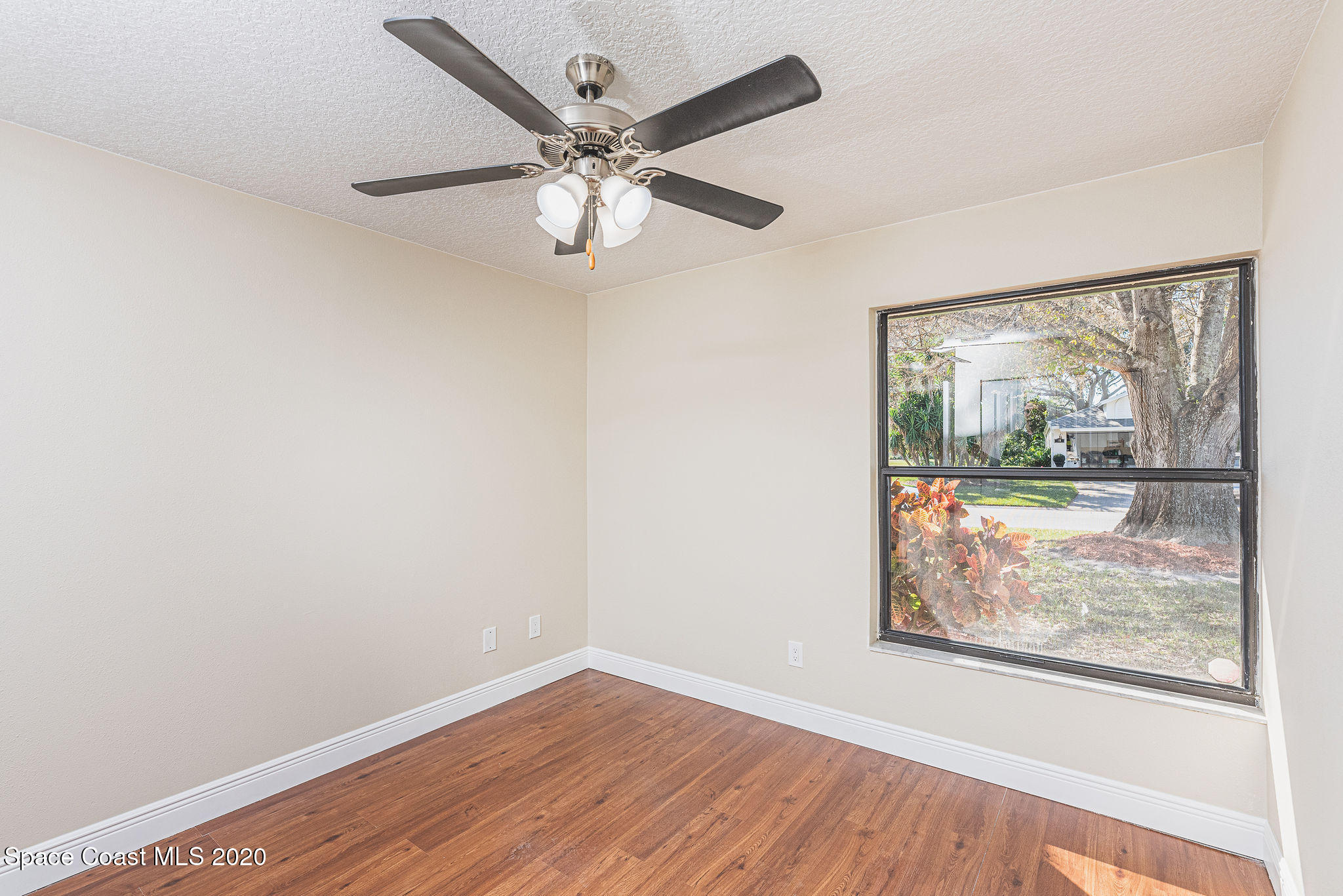 336 Myrtlewood Road Melbourne, FL 32940 - Photo 53 of 72 an empty room with wooden floor and windows