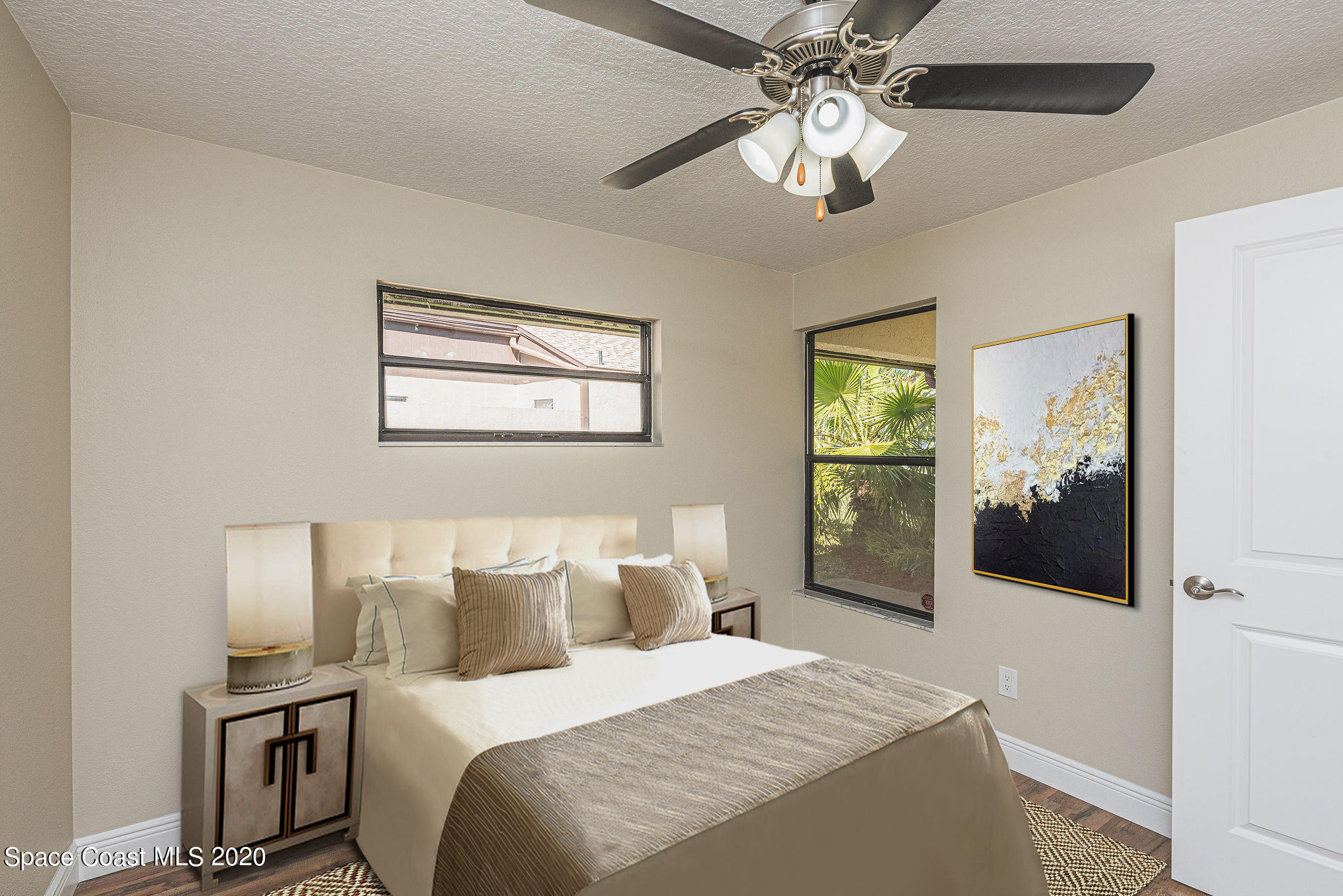 336 Myrtlewood Road Melbourne, FL 32940 - Photo 69 of 72 a bedroom with a large bed and a chandelier