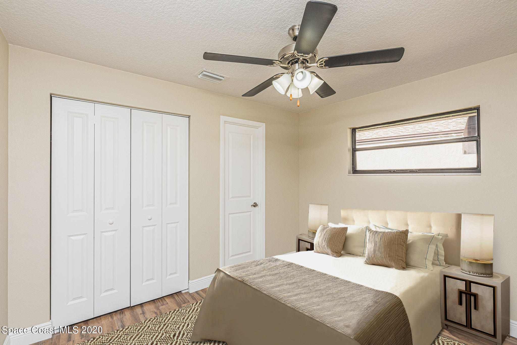 336 Myrtlewood Road Melbourne, FL 32940 - Photo 70 of 72 a bedroom with a large bed and a chandelier