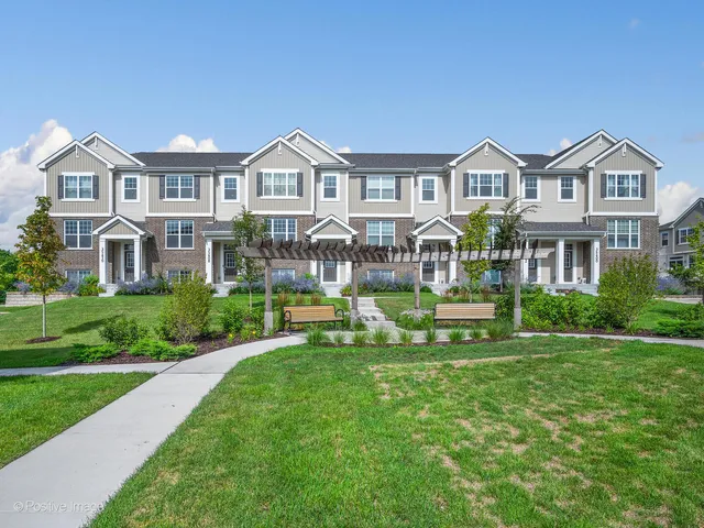 a front view of a house with a garden and yard