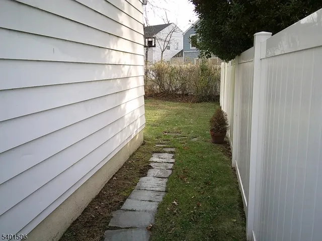 a view of a pathway of a house with a yard