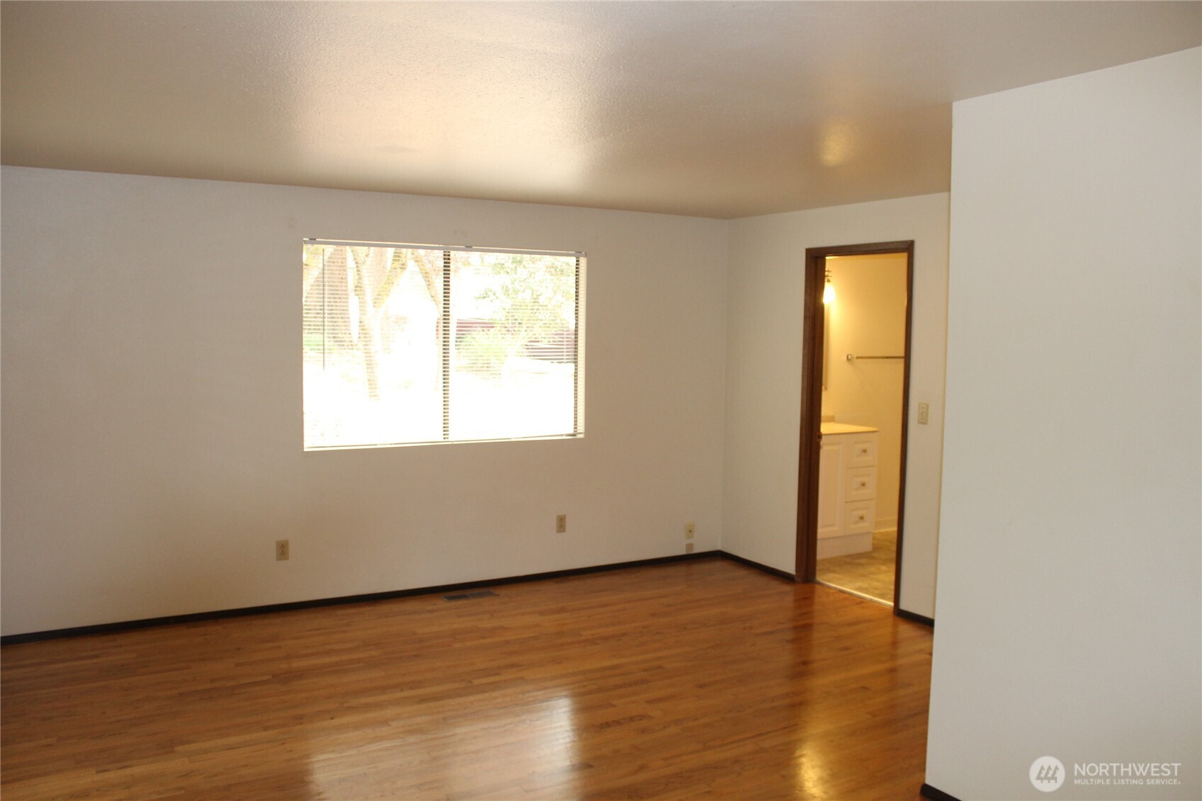 419 156th Place Northeast Bellevue, WA 98008 - Photo 11 of 22 an empty room with wooden floor and windows
