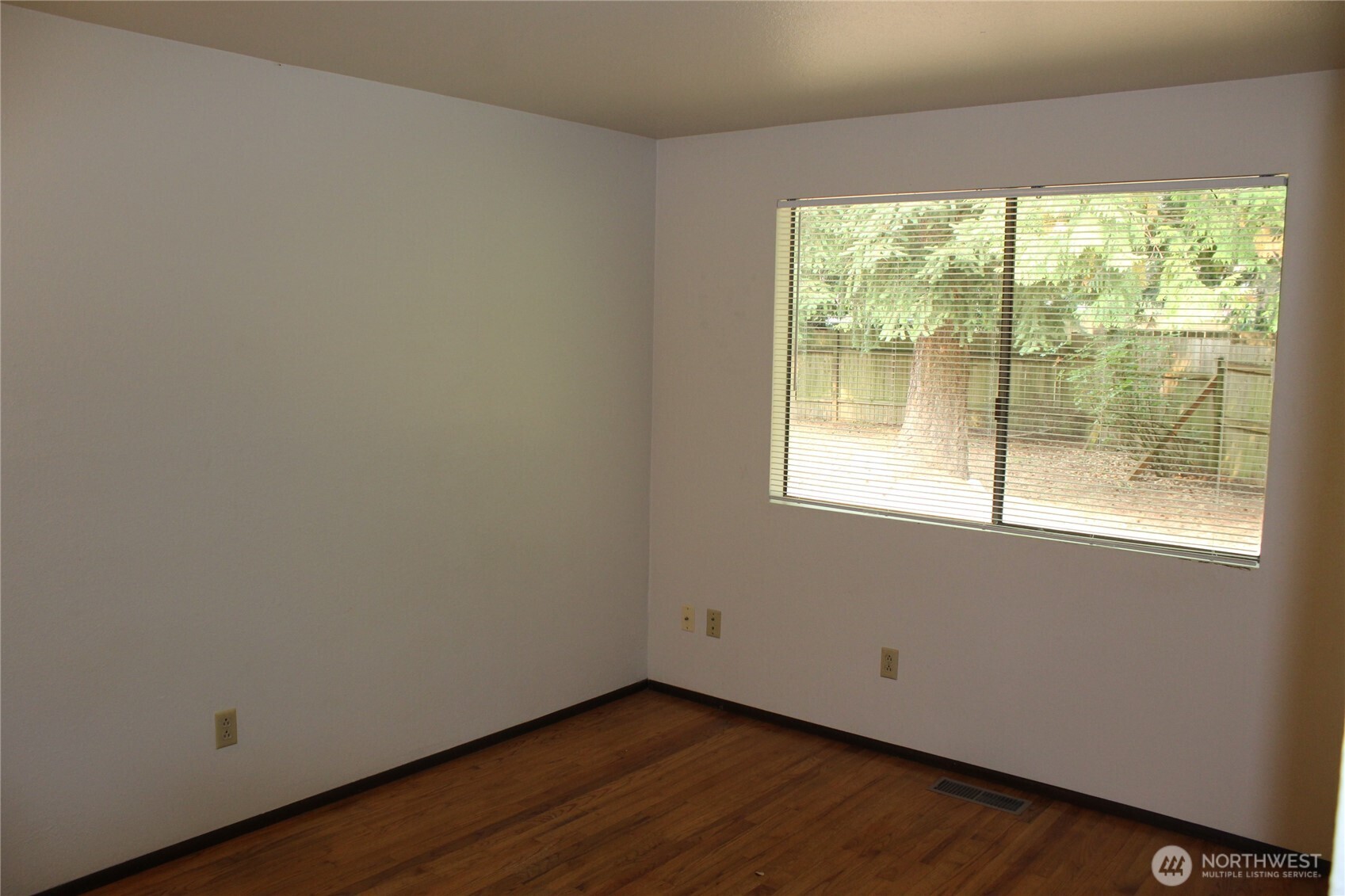 419 156th Place Northeast Bellevue, WA 98008 - Photo 15 of 22 a view of an empty room with wooden floor and a window