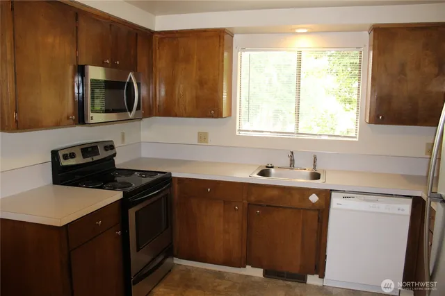 a kitchen with a refrigerator and a sink