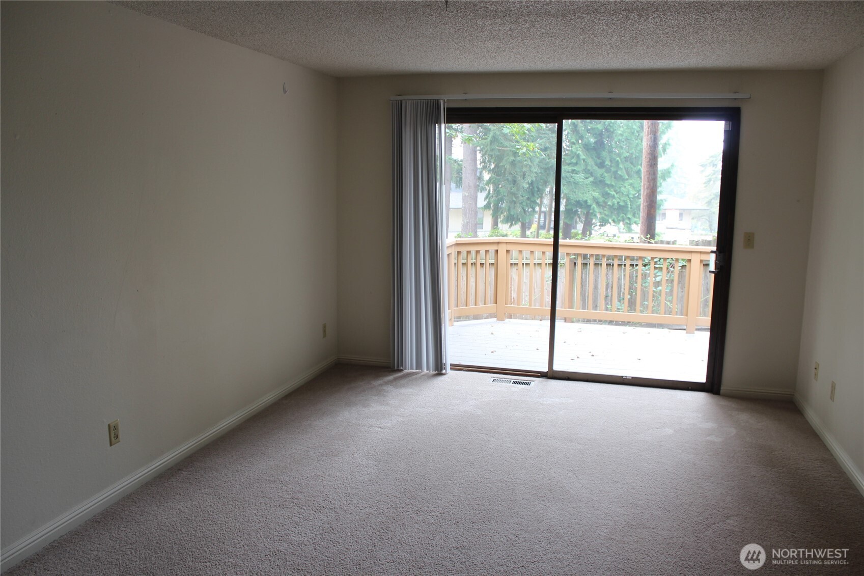 419 156th Place Northeast Bellevue, WA 98008 - Photo 9 of 22 a view of an empty room with wooden floor and a window