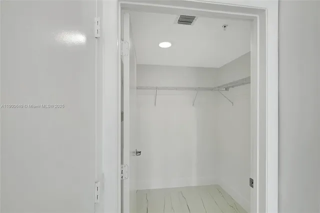 a view of a swimming pool with chairs and plants