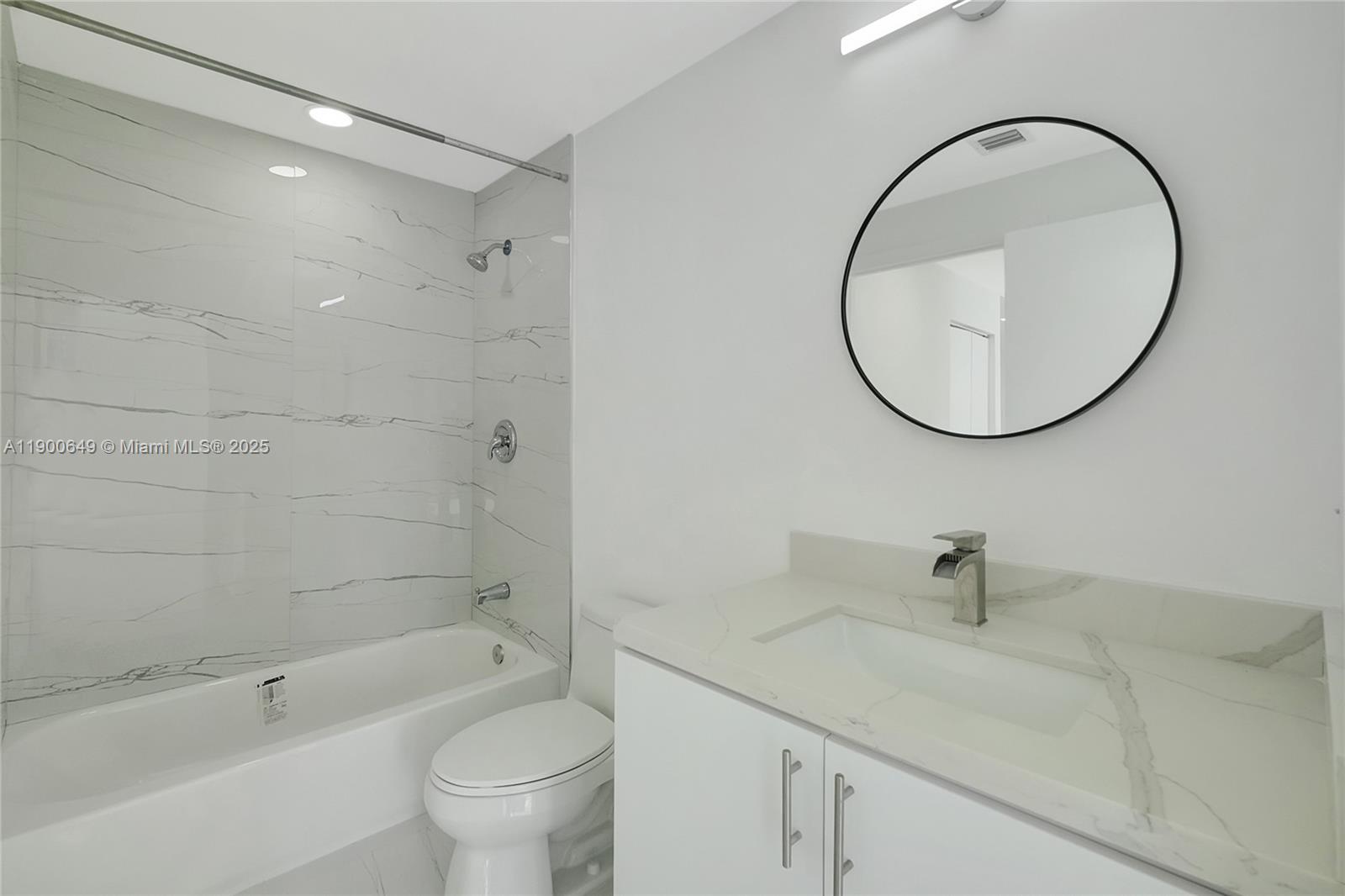 90 Southwest 3rd Street, Unit 1602 Miami, FL 33130 - Photo 25 of 81 a bathroom with a sink a toilet and a mirror