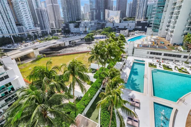 a swimming pool with outdoor seating and yard