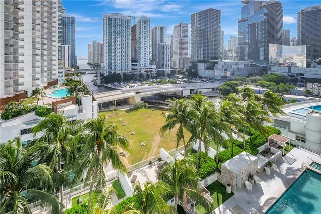 a view of a building with yard and sitting area
