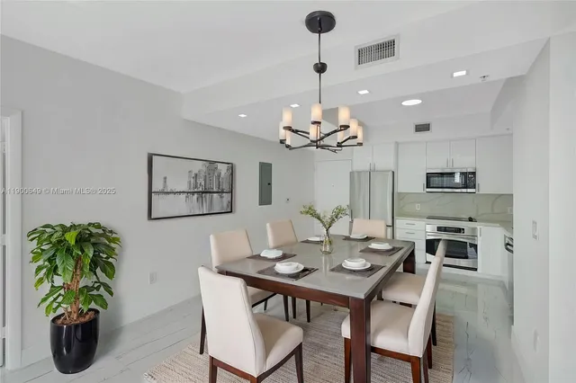 a view of a dining room and chandelier furniture and wooden floor