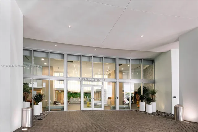 a kitchen with stainless steel appliances granite countertop a sink a counter space and a window
