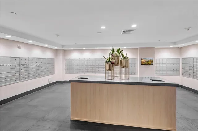 a kitchen with a refrigerator and white cabinets