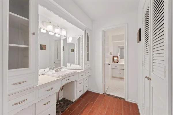 a spacious bathroom with a double vanity sink a mirror and shower