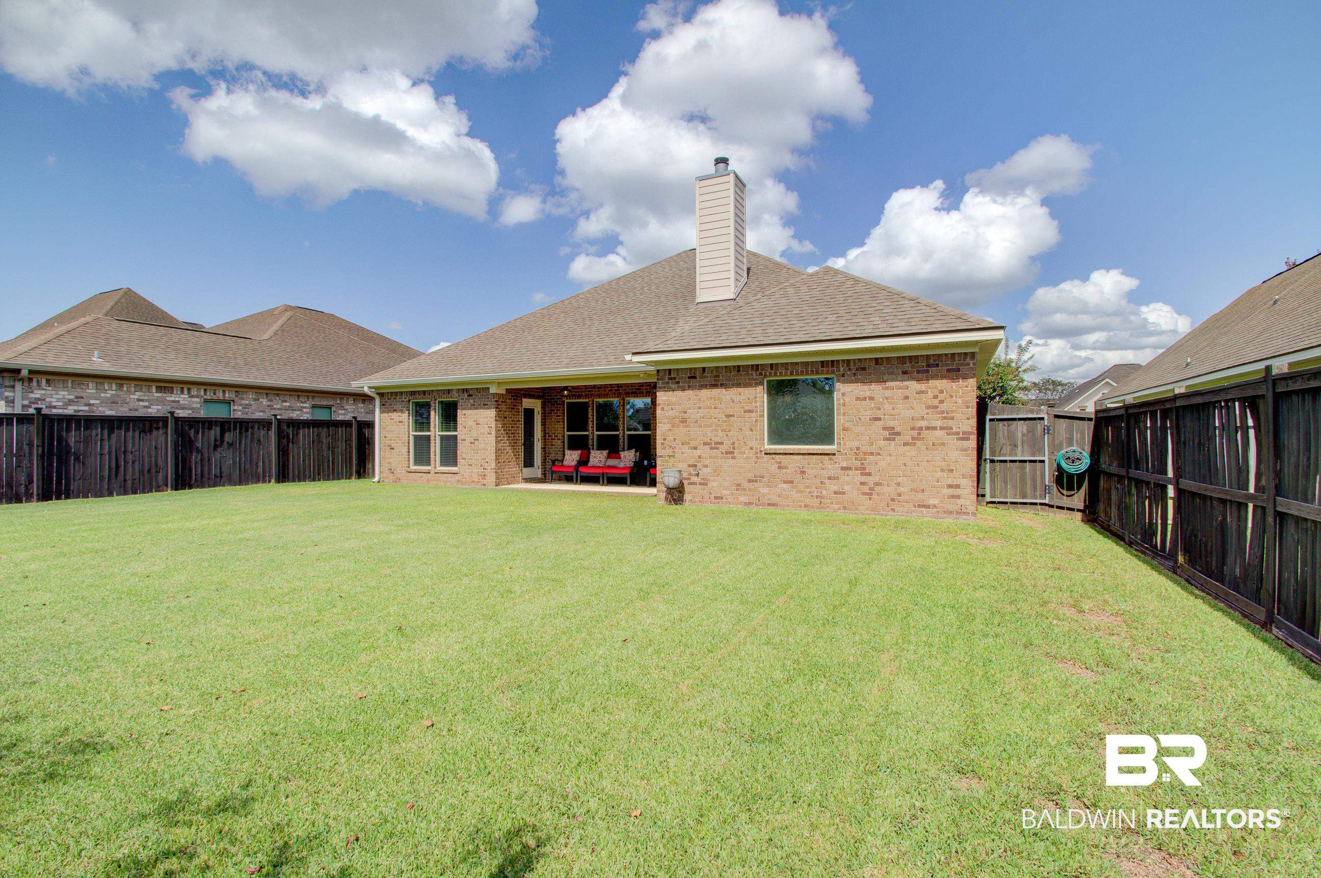 8625 Rosedown Lane Daphne, AL 36526 - Photo 23 of 29 Rear view of property with a patio and a lawn
