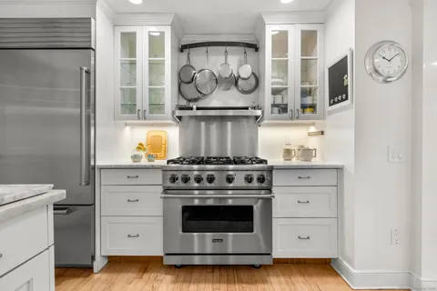 a stove top oven sitting inside of a kitchen