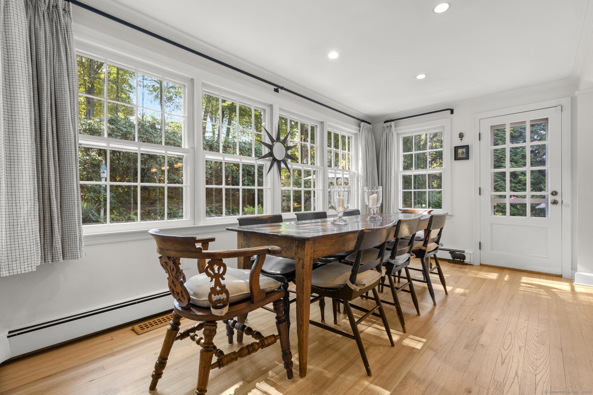 1165 Stillson Road Fairfield, CT 06824 - Photo 19 of 40 a dining room with furniture and wooden floor