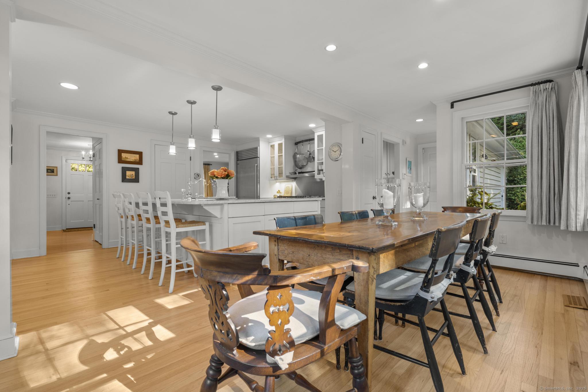 1165 Stillson Road Fairfield, CT 06824 - Photo 20 of 40 a view of a dining area with furniture and wooden floor