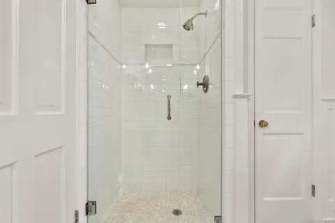 a bathroom with a glass shower door