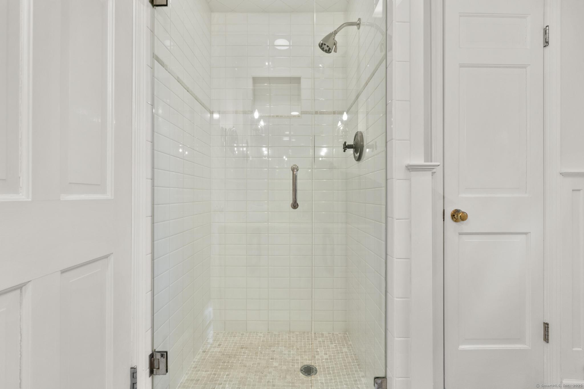 1165 Stillson Road Fairfield, CT 06824 - Photo 26 of 40 a bathroom with a glass shower door