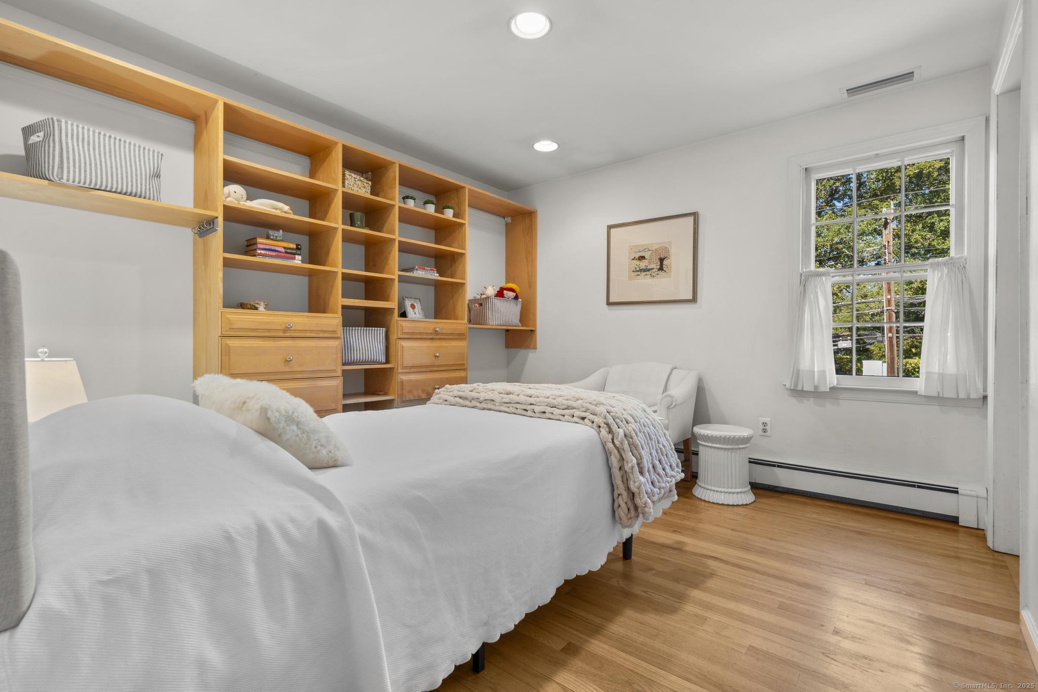 1165 Stillson Road Fairfield, CT 06824 - Photo 27 of 40 a bedroom with a bed and a window