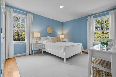 a livingroom with workspace and a window