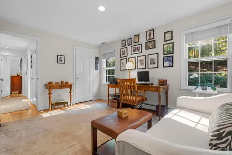 a living room with furniture a table and chairs