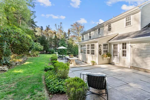 an aerial view of residential house with pool and garden