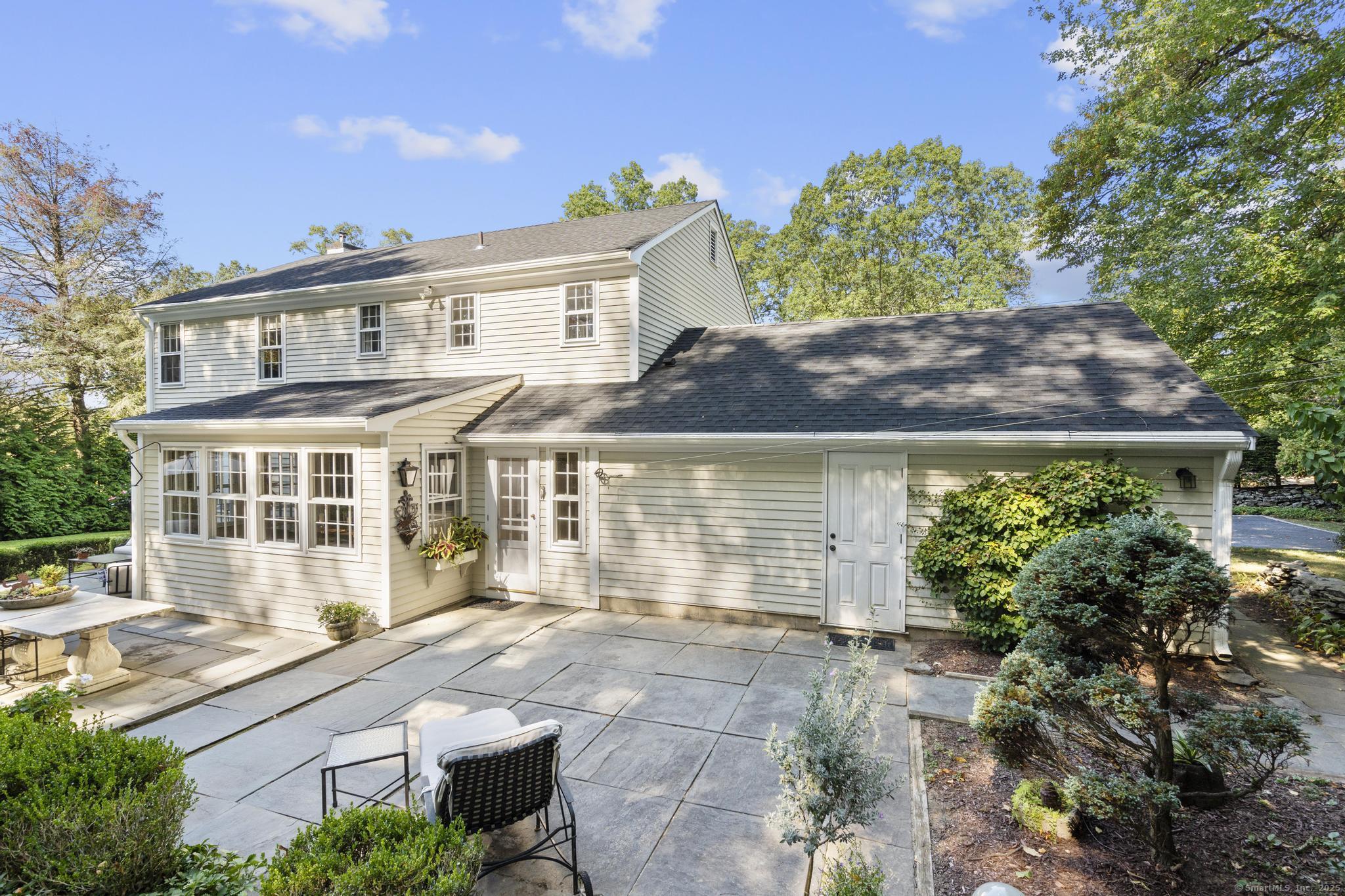 1165 Stillson Road Fairfield, CT 06824 - Photo 38 of 40 a front view of a house with a garden