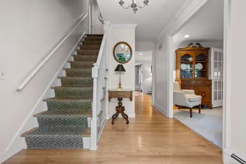 a view of an entryway with wooden floor and a rug