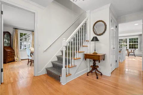 a view of entryway and hall with wooden floor