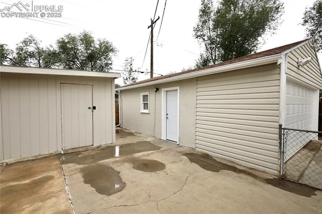 a view of a house with a backyard and garage