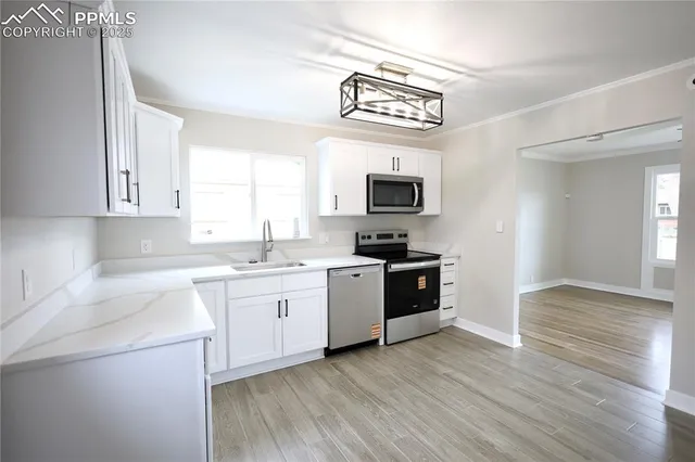 a kitchen with a stove cabinets and wooden floor