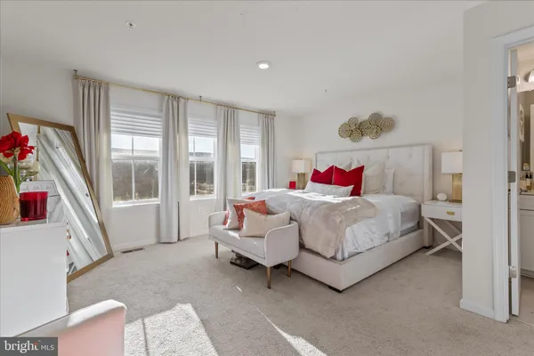 a spacious bedroom with a bed and a large window
