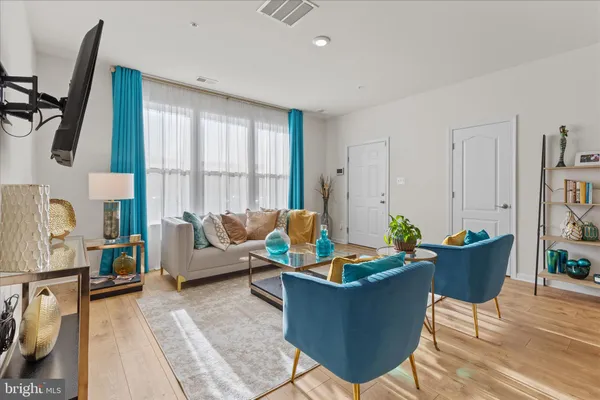 a living room with furniture and a large window