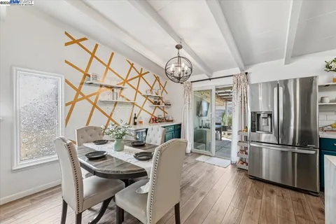 a view of a dining room with furniture large window and wooden floor