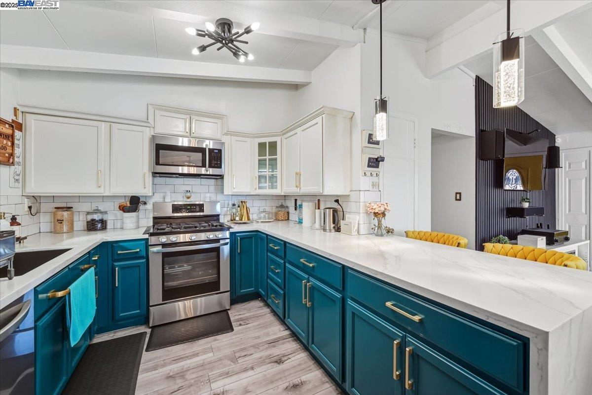 1481 Rieger Avenue Hayward, CA 94544 - Photo 22 of 53 a kitchen with stainless steel appliances granite countertop a sink a stove and cabinets