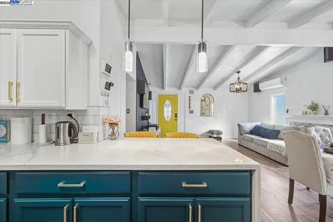 a large living room with kitchen island furniture and a chandelier